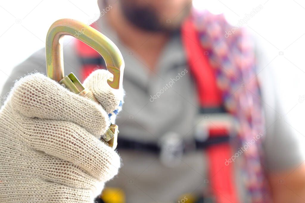 the arm with the open carabiner is extended by a latch to engage the system. works at the height of fall protection