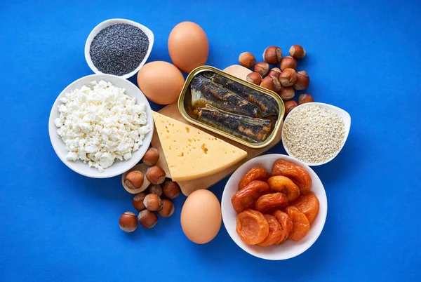 Various foods rich in calcium on a blue background