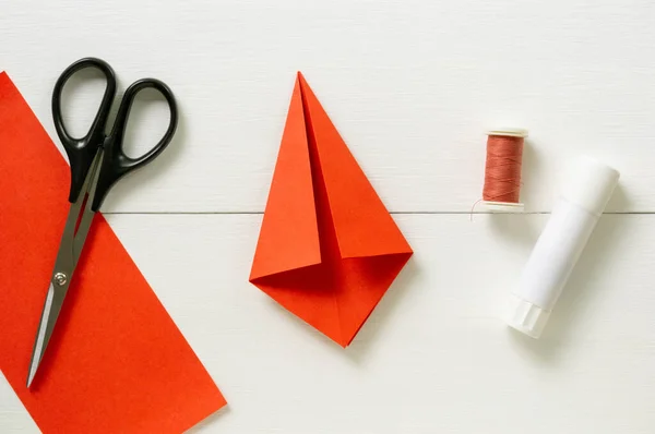 Step by step instructions for making origami paper lantern on christmas tree. Children diy project