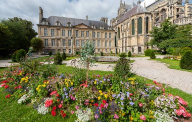 Park with flowers outside the cathedral in Reims clipart