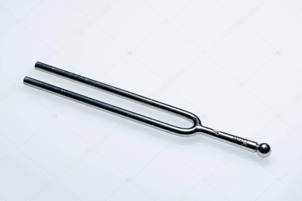 A tuning fork 440 Hz on a white background