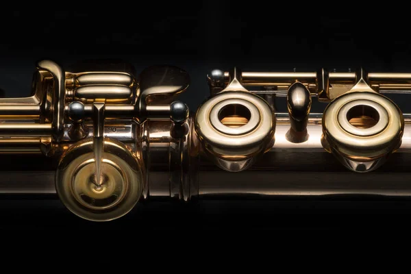 Details of a golden flute black background — Stock Photo, Image