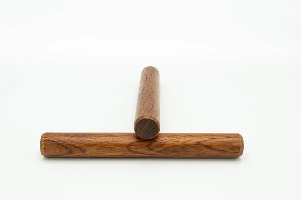 A pair of wooden claves lying on a white underground — Stock Photo, Image