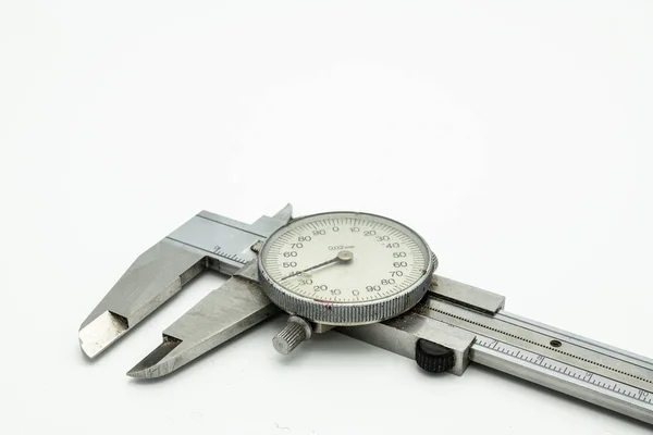 A dial caliper lying on a white background — 图库照片