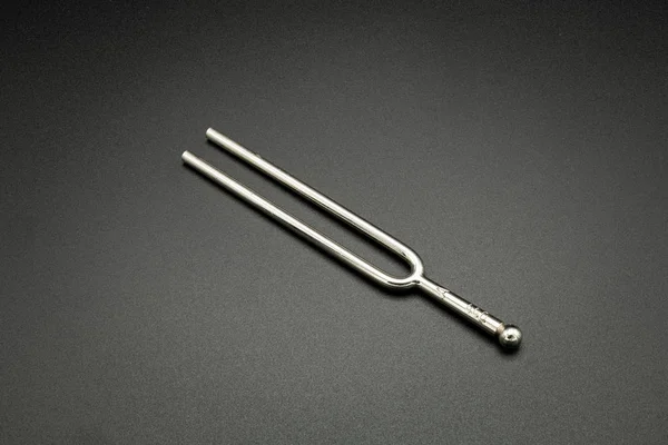 A tuning fork 440 Hz on a black background — 스톡 사진