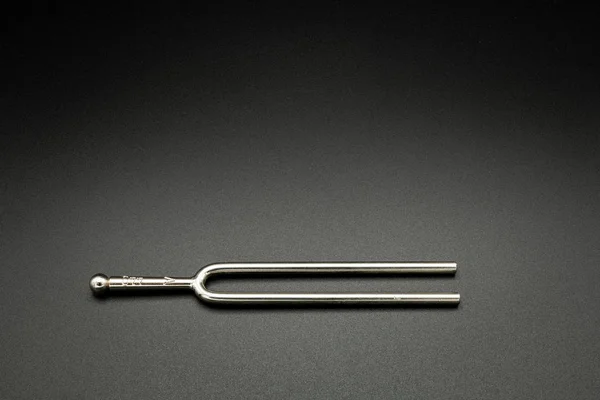 A tuning fork 440 Hz on a black background — Stock Photo, Image