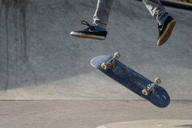 Vienna, Austria - 02/16/2020: Legs of a skateboarder jumping with his skateboard in midair
