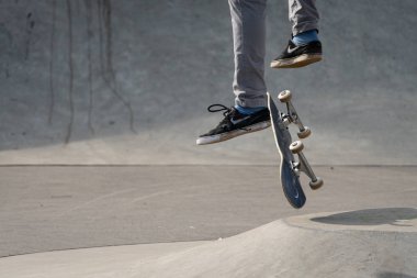 Vienna, Austria - 02/16/2020: Legs of a skateboarder jumping with his skateboard in midair