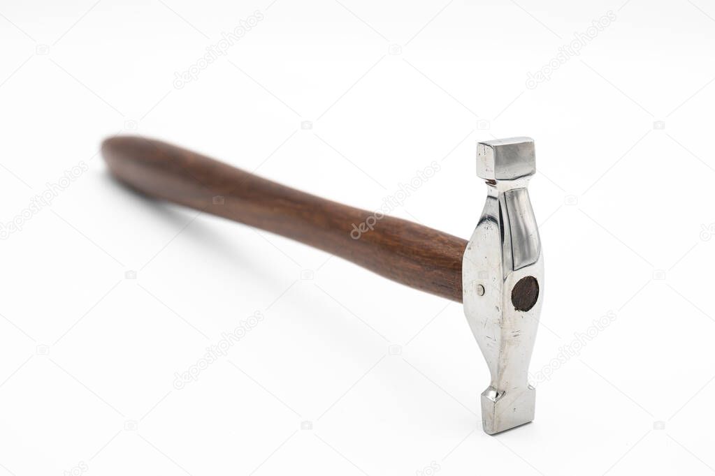 Closeup of a chasing hammer lying on a white background