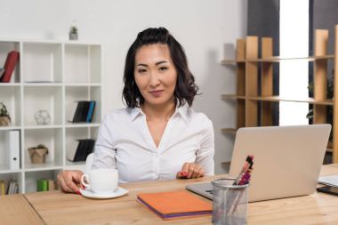 businesswoman with laptop and coffee  clipart