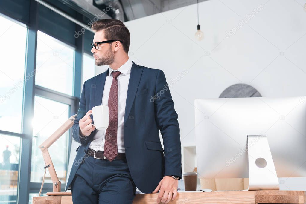 businessman drinking coffee in office