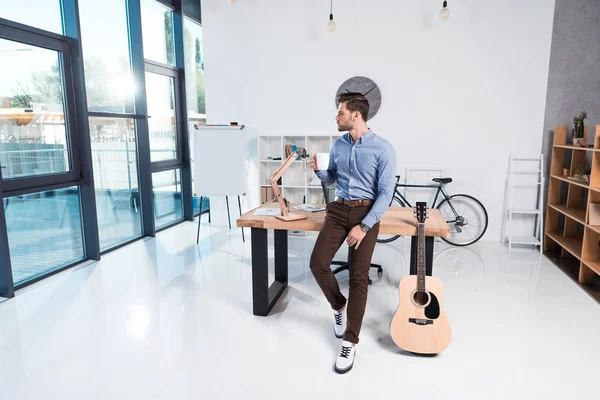 Businessman with coffee in office — Stock Photo, Image