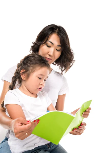 Mother and daughter writing in copybook — Stock Photo
