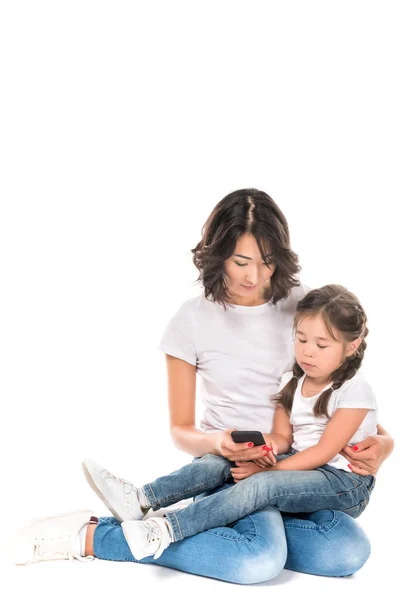 Mother and daughter using smartphone — Stock Photo