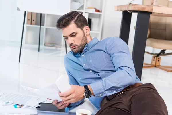 Homme d'affaires avec smartphone et documents — Photo de stock