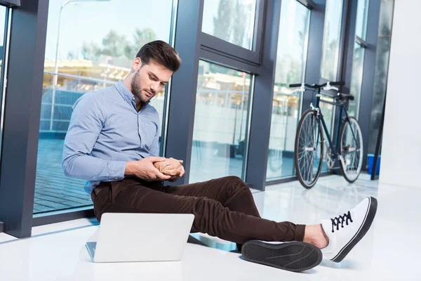 Businessman using laptop in office — Stock Photo