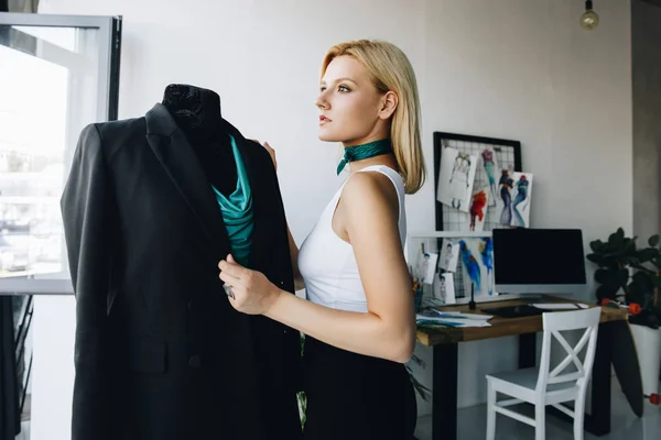 Dressmaker working with dummy