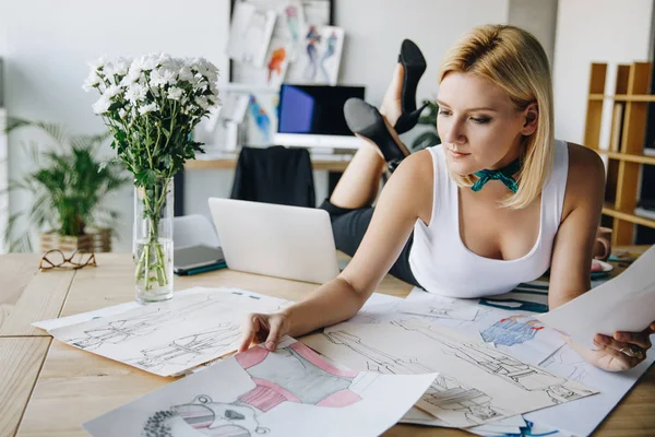 Young fashion designer with sketches — Stock Photo, Image