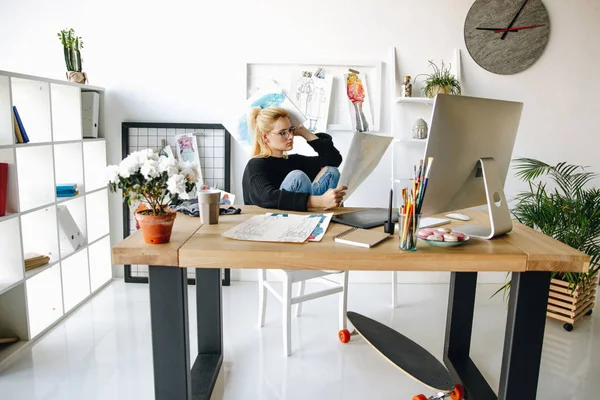 Designer with sketches at workplace — Stock Photo, Image