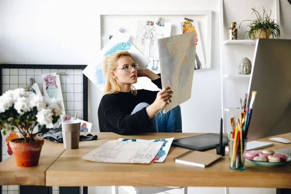 Designer with sketches at workplace — Stock Photo, Image