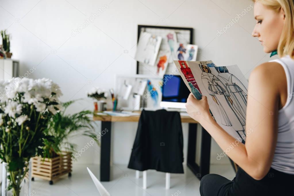 young fashion designer with sketches