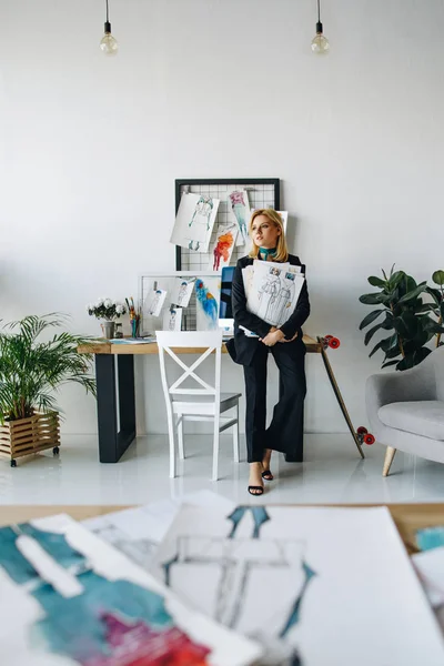 Young fashion designer with sketches — Stock Photo