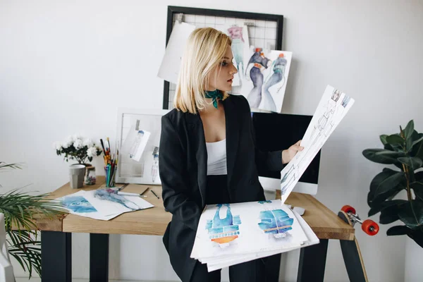 Young fashion designer with sketches — Stock Photo