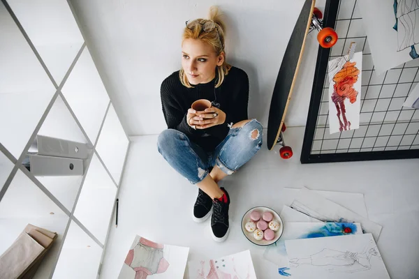 Fashion designer with cup and macarons — Stock Photo