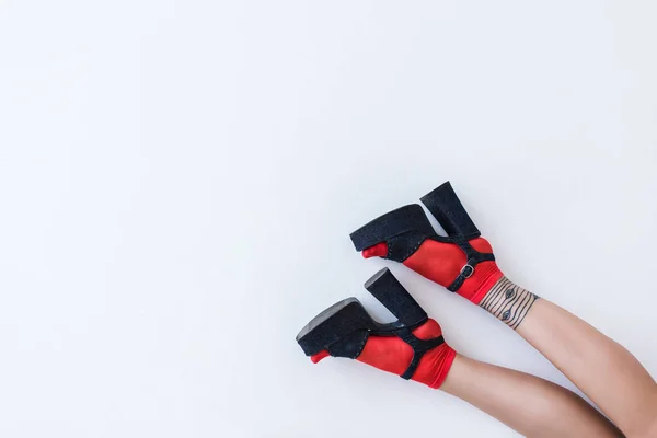 Feet in fashionable heels — Stock Photo