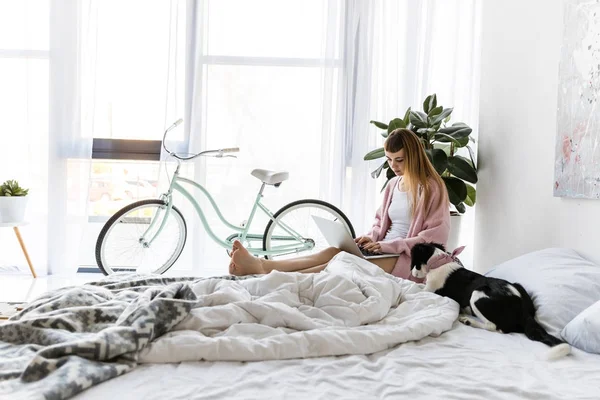 Young woman using laptop in morning at home — Stock Photo