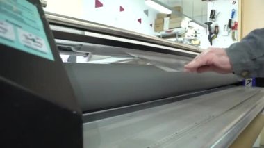 İşimiz. Bir film hazırlama / işçi laminar filmde doldurur.