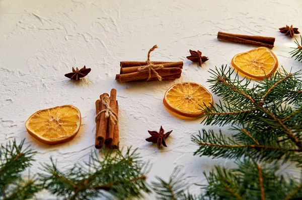 New year food decorations with fir branches and traditional spices for mulled wine  anise stars, cinnamon sticks, dried oranges. New Year composition greeting card. Holiday mood. Side view