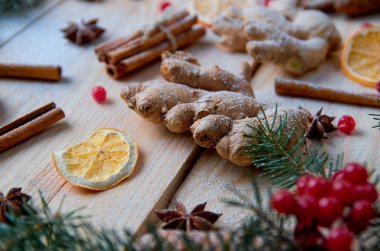 Toz zencefil için Noel ekmek portakal, anason, tarçın, anason ahşap arka plan üzerinde bulanık geleneksel baharat ile kapatın. Noel ağacı dalı ile dekore edilmiş kartopu. Yeni yıl kompozisyon