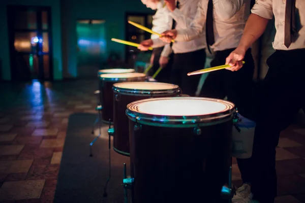 hands with drum sticks and drum