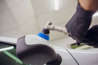 Araba - işçi oto tamircisi yörünge Parlatıcı ile ayrıntılı. Araba ayna Lehçe. Seçici odak. Eller yörünge Parlatıcı ile