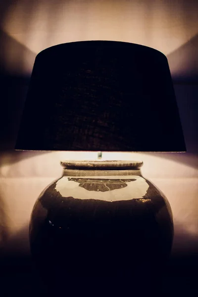 Lamp night light in a dark background. Vintage effect style picture. Minimal concept.