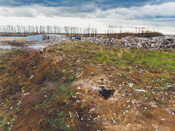 Duży wysypisko śmieci rozciąga się równolegle do rzeki, Góry śmieci z zachmurzone niebo z powrotem ziemi w świetle dnia, Odpady ma produkty naftowe są głównym. — Zdjęcie stockowe