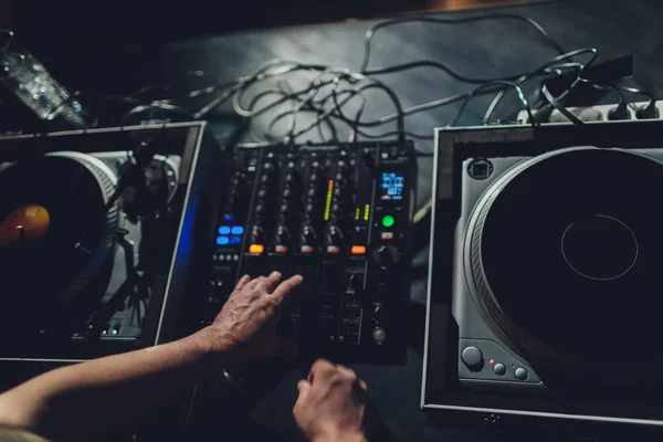 Dj hands on equipment deck and mixer with vinyl record at party. — Stock Photo, Image