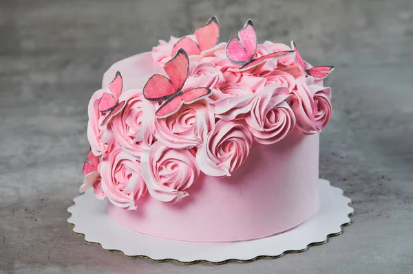 Bovenaanzicht van een vers gebakken cake versierd met roze poedersuiker rozen weergegeven op een taart staan meer dan een zwarte achtergrond met copyspace. — Stockfoto