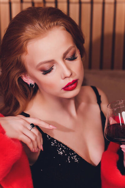 elegant young woman with jewelry at restaurant.
