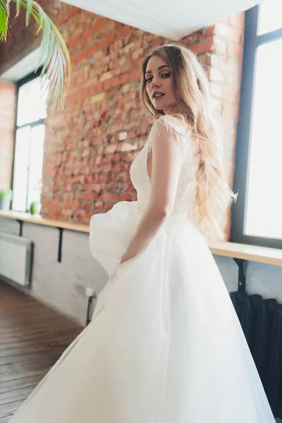 The beautiful woman posing in a wedding dress. — Stok fotoğraf