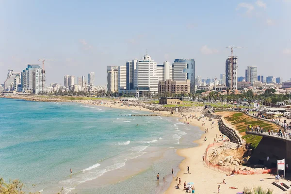 Tel Aviv, Israel, August 12th, 2018: Lots of tourists and locals are swimming at blue Mediterranean sea and spending their vacation at the beach of Tel Aviv, Israel in summertime. israel surfing Royalty Free Stock Photos