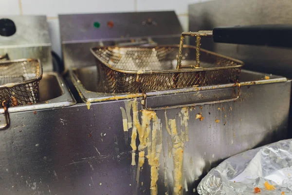 Deep fryer with oil on restaurant kitchen.