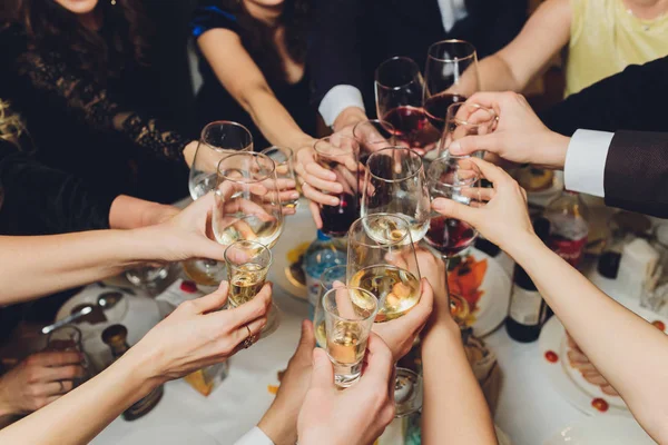 Clinking glasses with alcohol and toasting, party. — Stock Photo, Image