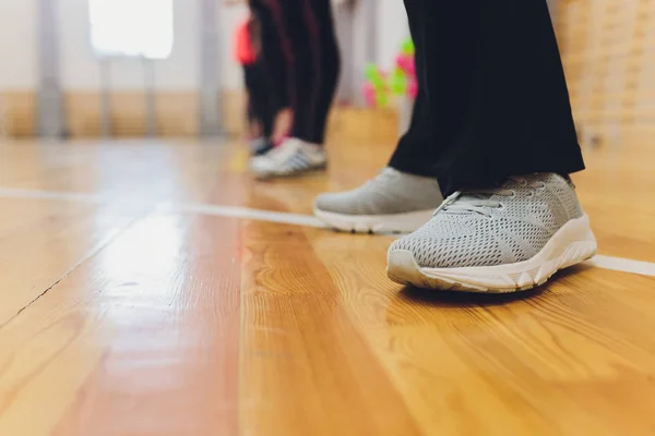 Legs. Around the object is a gray background. The concept of sports shoes and comfort.