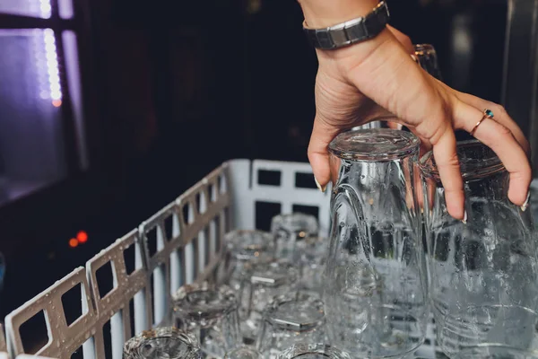 Close-up photo of clean washed and polished bar and pub glasses hanging over Empty glasses ware on table in night club with reflection Empty clean bar glasses — 스톡 사진