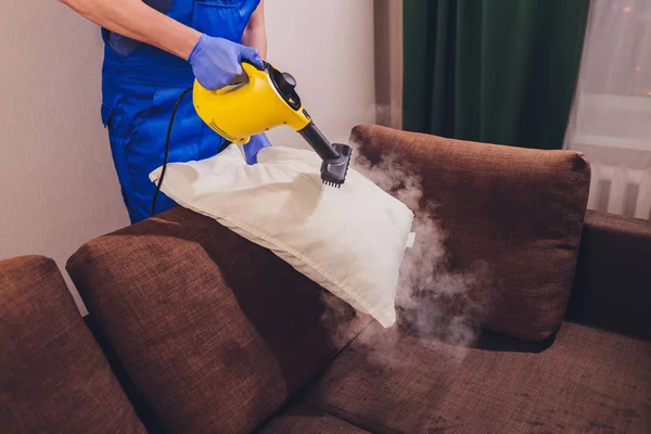 Using dry steam cleaner to sanitize pillow. — Stock Photo, Image