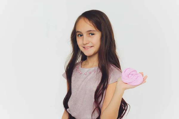 Young girl playing with slime. Isolated on white background. — Stock Photo, Image