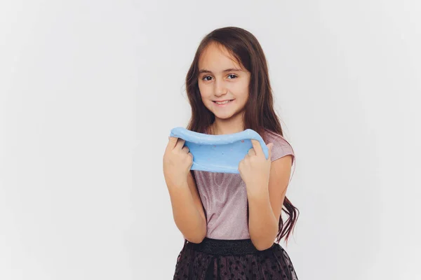 Young girl playing with slime. Isolated on white background. — Stock Photo, Image