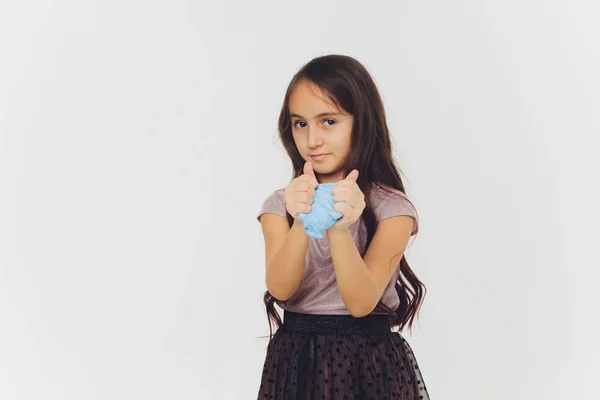 Young girl playing with slime. Isolated on white background. — Stock Photo, Image